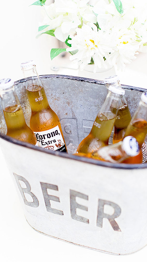 Present cold beers in metal containers to add a rustic look to your summer wedding