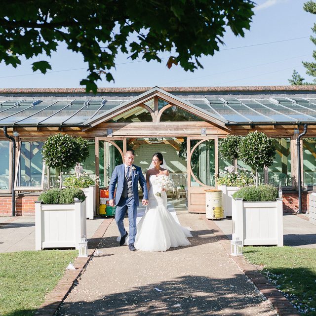 : A Bride and groom take a moment away from guests I the gardens at Gaynes Park in Essex